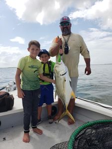 Three people fishing with one big fish in Texas