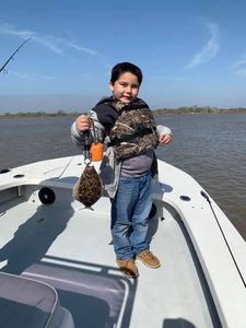 Fisherman holding a Southern Flounder in Matagorda