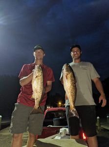 Two anglers fishing in FL with their catch