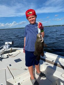 A fisherman catching a Tripletail fish in FL