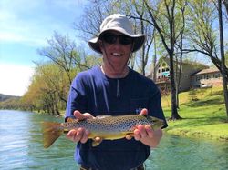 A fisherman holding a sea trout in AR
