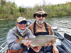 Angler proudly holding a large rainbow trout in Gassville