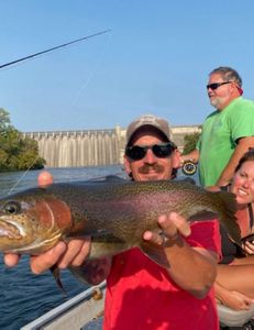 Angler holding a rainbow trout in AR