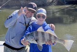 Fisherman holding a big black drum fish in GA