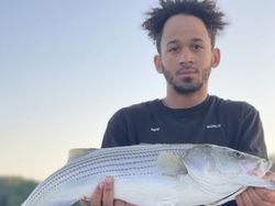 A single fisherman reeling in a 22-inch catch in GA