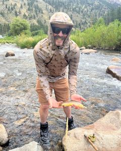 Angler catching a rainbow trout in Longmont