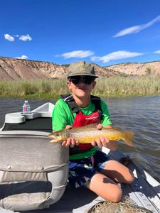 Angler with a rainbow trout in Colorado