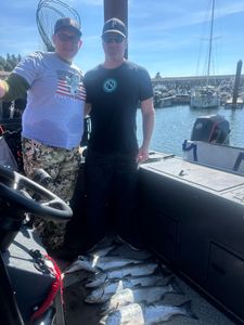 Two anglers fishing in Oregon, enjoying a great catch