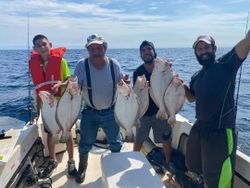 Four people fishing in Narragansett with a great catch
