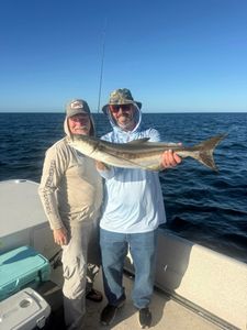 Two people fishing for a cobia in Florida