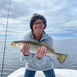 Angler catching a spotted weakfish in FL