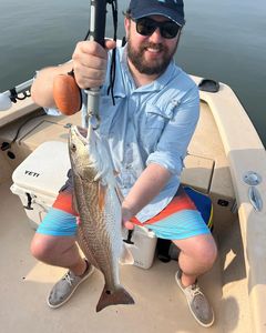 Angler catching a redfish in Atlantic Beach