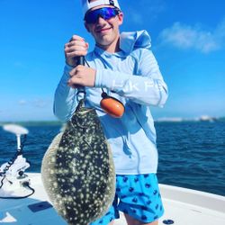 Angler landing a Southern Flounder in Atlantic Beach