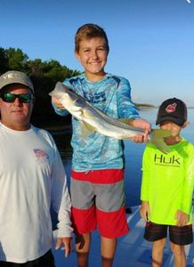 Three people fishing in Naples, Florida
