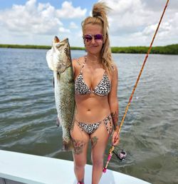 A person fishing in the waters of Naples, Florida