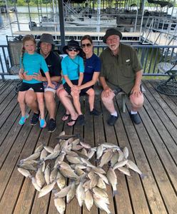 Five people enjoying a fishing trip in Quinlan