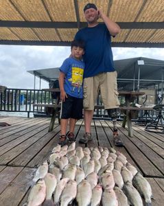 Two anglers with a catch of two fish in Quinlan