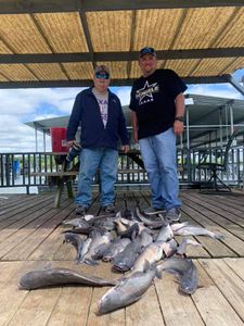 2 people fishing for a large 24-inch fish in Quinlan