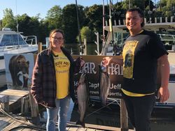 Two anglers fishing in Manistee with 2 big fish