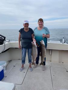 Two anglers fishing with rods in MI