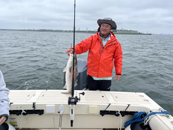 A 17-inch striped bass caught using a variety of techniques on a rainy day.