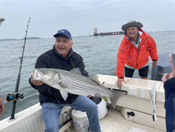 Reeled in a huge striped bass after a long day of fishing on the water!
