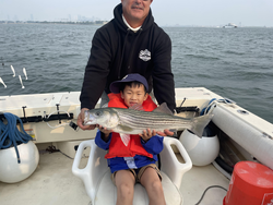 Big Striped Bass reeled in during a partly cloudy day in Hingham!