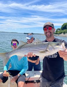 Angler with a striped bass in MA