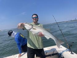 Huge Striped Bass reeled in during a partly cloudy day!