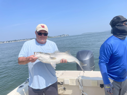 Striped Bass action in Hingham: Deep sea jigging meets partly cloudy skies!