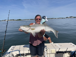 Huge striped bass reeled in on a partly cloudy day!