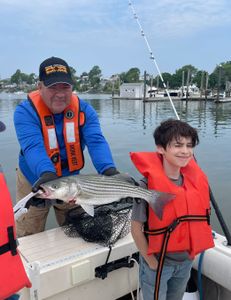 Striped bass caught by two people in Hingham