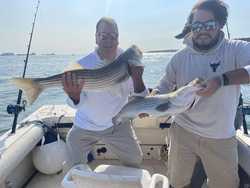 Reeling in two big Striped Bass on a crystal-clear day!