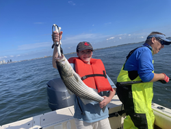 Striped bass reeled in as storms brew on the horizon!