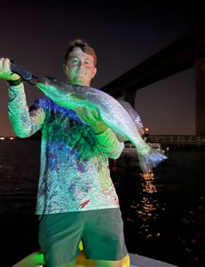 One fisherman reeling in a big fish in FL