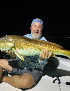 A person fishing in FL with a great catch