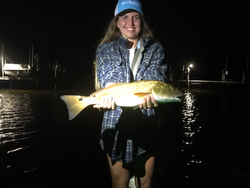 Huge redfish landed while jigging in Milton's challenging weather!