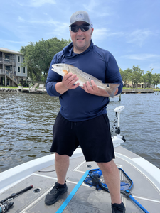 A 14-inch redfish reeled in during a cloudy afternoon in Milton!