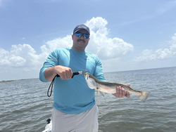 A massive spotted weakfish caught on an epic day of jigging, fly fishing, and heavy and light tackle action.