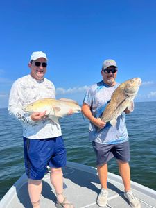 Two anglers proudly display their catch in LA