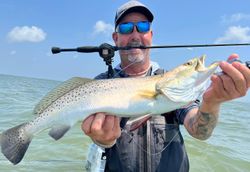 Lone angler reeling in a 29-inch fish in TX