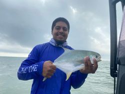 A fisherman catches a Florida Pompano fish in Pleasanton