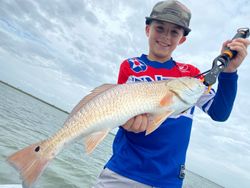 A lone angler reels in a fish in TX