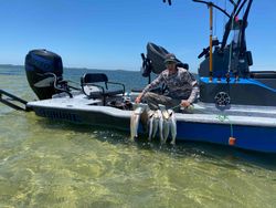 Angler with 2 spotted weakfish, fishing in TX