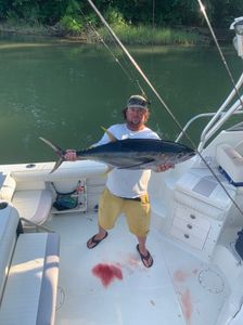 A fisherman with a 28-inch yellowfin tuna caught in VA