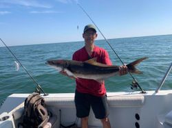 A fisherman with a 29-inch cobia fish in VA