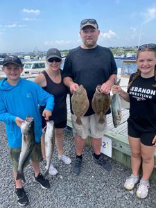 4 striped bass, southern flounder, and bluefish caught at Barnegat Light