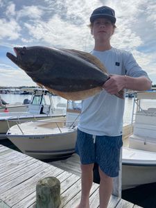 Angler fishing at Barnegat Light with a 23-inch fish