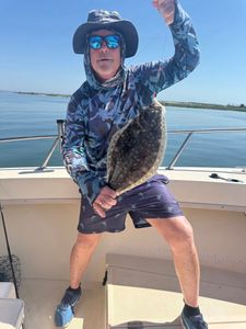 An angler fishing for a summer flounder in NJ
