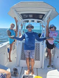 Three people enjoying a fishing tour in FL